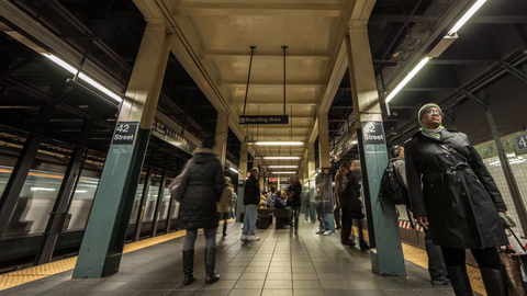 people on subway station platform at 42nd Street - trains speeding in timelapse 4K of NYC