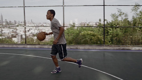 kid dribbling slowly to basket and shooting layup in slow motion - basketball practice in summer