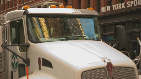sanitation truck turning corner in Greenwich Village NYC