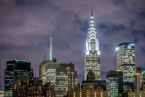 Chrysler Building and MetLife skyscraper at night with bright lights in Manhattan NYC