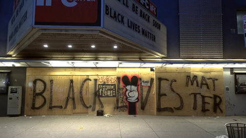 Black Lives Matter writing on wall of boarded up movie theater also playing BLM feature at IFC in New York City NYC