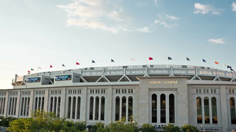 Yankee Stadium with flags on exterior on sunny day in summer - the Bronx NYC
