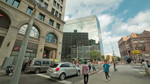 panning in Cooper Square and Astor Place with Starbucks Coffee house on summer day in Manhattan NYC