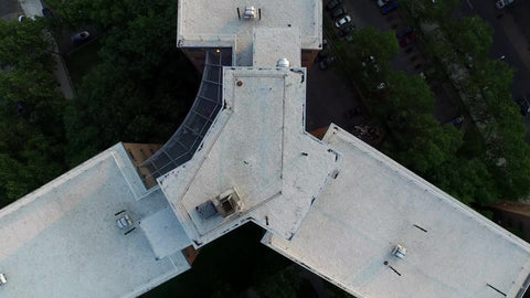 lifting off rooftop of Harlem projects - aerial above Uptown building