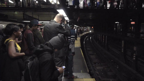 4 train pulling into subway station with crowd of passengers waiting on platform, 1080 HD in NYC