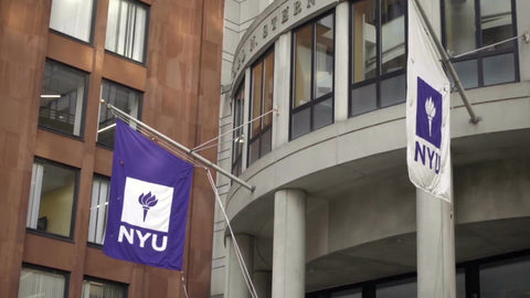 NYU flags panning to Stern School of Business building - students entering and exiting