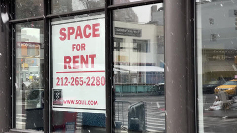 space for rent sign in empty retail store snowing winter Manhattan New York City NYC
