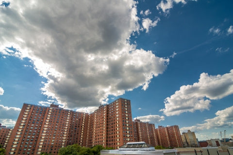 red brick buildings with blue sky and clouds on sunny summer day
