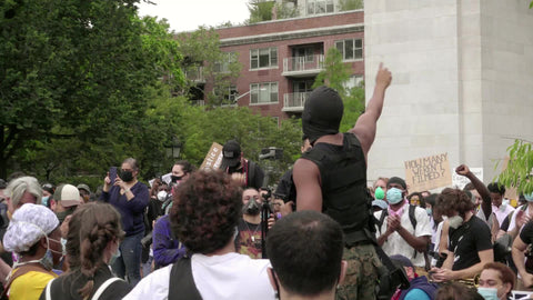 man in mask addressing crowd of activists and supporters of the Black Lives Matter movement in Washington Square Park NYC