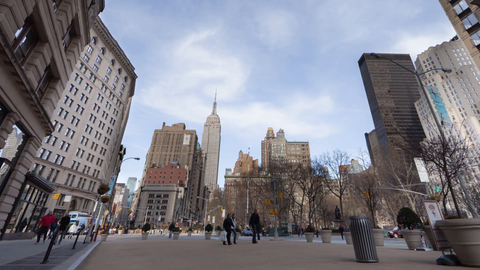 Empire State Building and Madison Square Park with people walking in fast motion in Manhattan NYC - 4K timelapse
