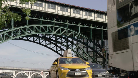 elevated 1, 2 and 3 subway train at 125th street in Harlem with cars below driving on street 4K