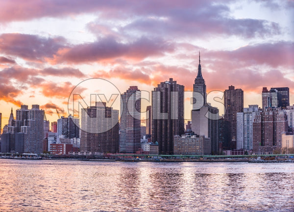 Manhattan skyline with Empire State Building from across East River in colorful HDR sunset