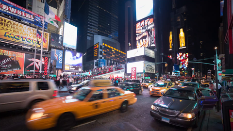 Times Square timelapse at night with bright Coca-Cola ad, billboards and signs - taxis speeding in traffic - 4K in NYC