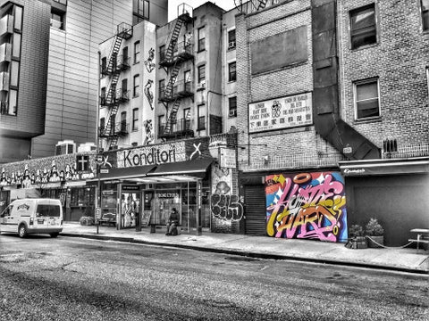 colorful graffiti piece on black and white street on Lower East Side of Manhattan in HDR