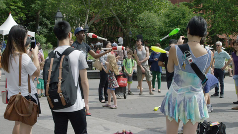 performers juggling bowling pins in Washington Square Park in summer - slow motion 4K NYC