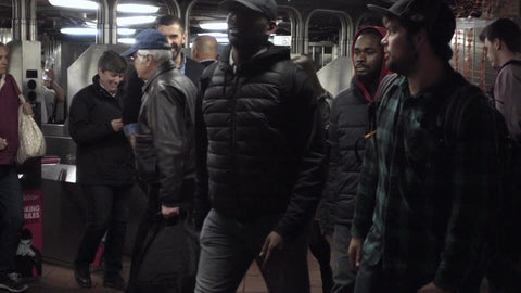 happy people traveling in subway station travelers entering turnstiles taking public transportation in NYC slow motion