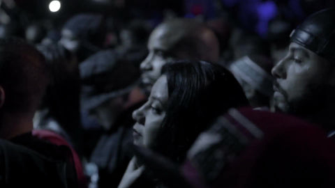 closeup of faces in crowd - standing in concert - fans watching hip hop music show