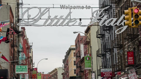 welcome to Little Italy sign in Chinatown on Chinese New Year parade - crowded with people behind police barrier - traffic cops