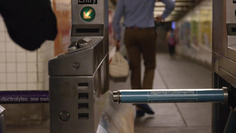 hand swiping Metro Card at turnstile in subway station in slow motion