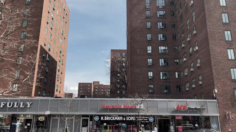 driving past stores shops on 1st Avenue in Stuyvesant Town Manhattan red brick buildings New York City NYC