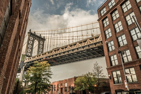 Manhattan Bridge street view between two buildings in Brooklyn during day in NYC