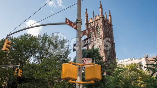 intersection of 5th Ave and 11th Street with First Presbyterian Church on sunny day in Manhattan