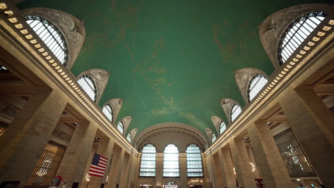 busy Grand Central Station interior main big room - tilting down from ceiling to stairs in summer NYC