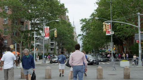 view of Empire State Building and Lower 5th Ave from Washington Square Park South - people walking in summer - 4K slow motion Manhattan NYC