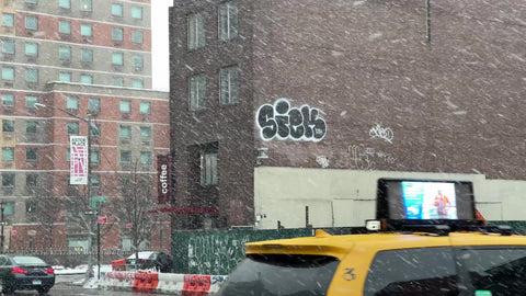 sick graffiti name on brick wall snow storm blizzard snowing winter East Village New York City NYC