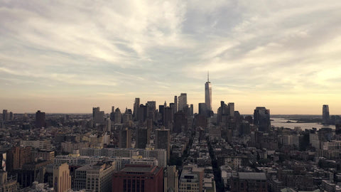 late moving aerial shot pulling backwards from Freedom Tower over Manhattan New York City NYC