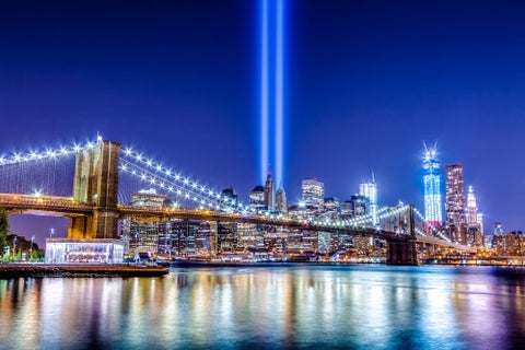 beautiful HDR night shot of Brooklyn Bridge and Manhattan skyline with city lights reflecting off East River