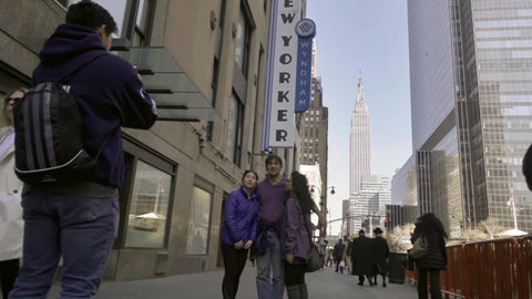 family taking pictures in front of Empire State Building New Yorker Manahttan New York City NYC