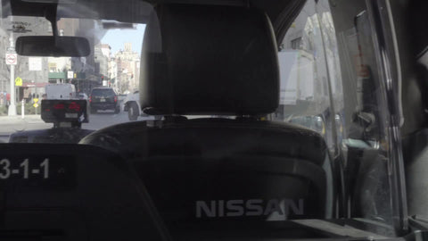 interior of taxi cab - backseat passenger view of driver's front seat in NYC