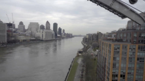 crossing East River from high aerial tram view over water in 1080 HD in NYC
