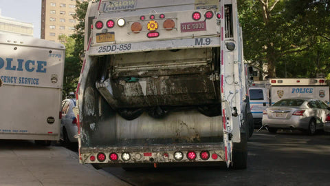 garbage truck backing up next to police vehicle in Harlem, Uptown Manhattan 4K