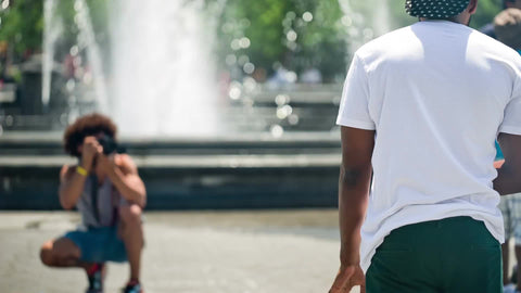 photographer taking picture of model in Washington Square Park on summer day in NYC