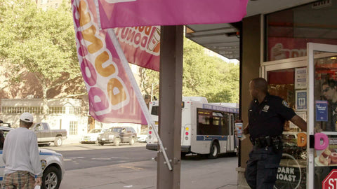 police officers - partners coming out of Dunkin Donuts in Harlem New York City - NYPD cops at donut shop