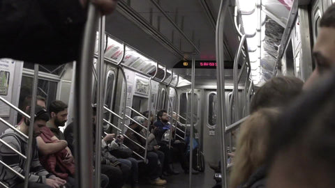interior subway carriage with people sitting, riding train