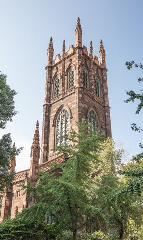 First Presbyterian Church with green trees on beautiful day in Manhattan