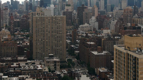 aerial moving over buildings tilting up to Empire State Building Manhattan NYC
