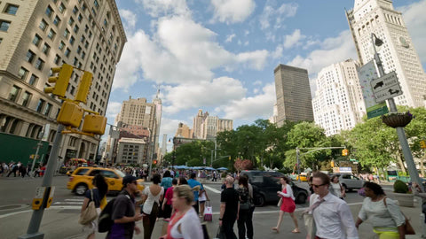 panning view of Madison Square Park and Flatiron Building on 23rd Street and 5th Ave on summer day in Manhattan