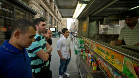 Middle-Eastern men waiting for food at Halal truck on 5th Ave in Manhattan