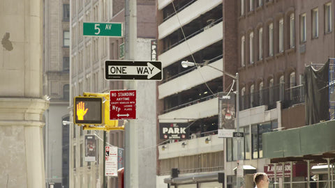 5th Ave sign with cars driving - one way sign and don't walk light