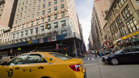 taxicab driving on Manhattan street - taxis and cars on avenue - cabs in Midtown