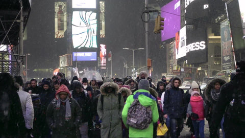 people crossing street - busy crowded Times Square crosswalk - snowing in Manhattan winter