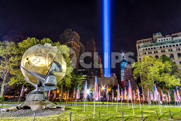 Battery Park 911 memorial beams with American flags at night
