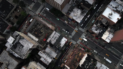 Midtown Manhattan overhead traffic rotating aerial over street buildings rooftops New York City NYC