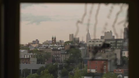 map of New York City on subway station window in Brooklyn with Empire State Building rack focus