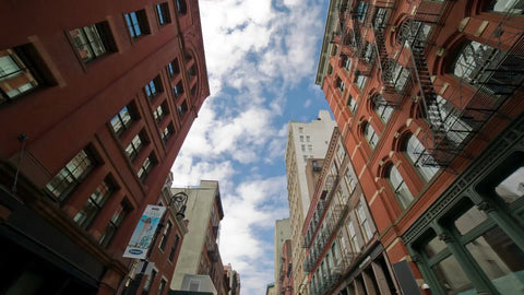 SoHo buildings on summer day tilting down to cobblestone street in NYC