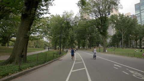 Central Park bicyclists riding bicycles on summer day in NYC